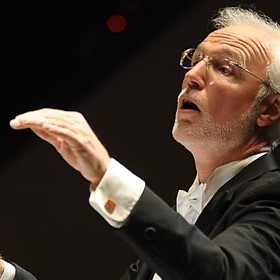 Professor Thomas Evans conducting at a performance.